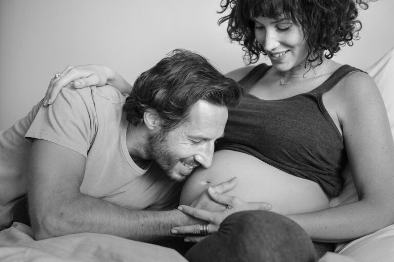 Husband kissing baby bump